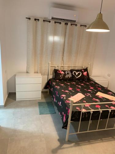 a bedroom with a bed with a heart pillow at EXCLUSIVE COMFORT PREMIUM in Beer Sheva