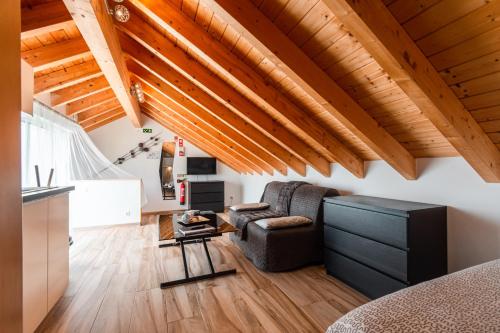 a living room with a couch and a table at Casa do Bairro by CosyCasa Praia Peniche in Peniche