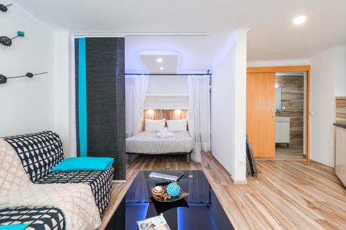 a living room with a couch and a bed at Casa do Bairro by CosyCasa Praia Peniche in Peniche