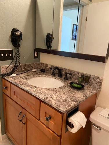 a bathroom counter with a sink and a phone at GetAways at Park Regency Resort in Park City