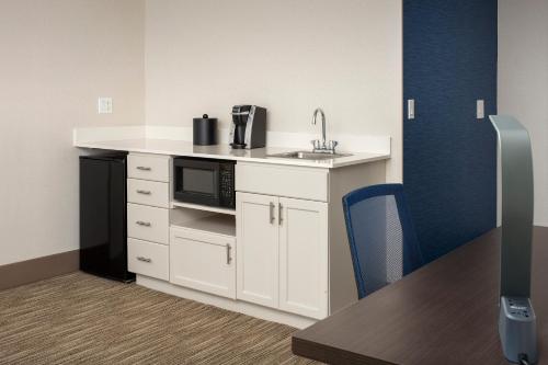 a kitchen with a sink and a microwave at Holiday Inn Express Puyallup by IHG in Puyallup