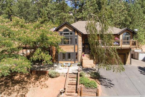 a wooden house with a porch and a balcony at Mandala Springs in Cobb