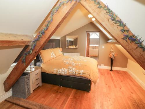 a bedroom with a bed in the attic at Rhiw Afallen in Caernarfon