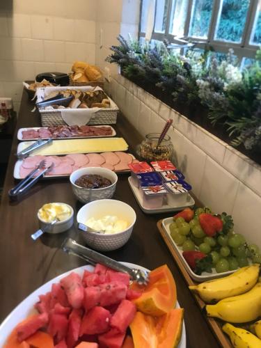 a buffet with fruits and other food on a table at Solar 197 Pousada in Timbó