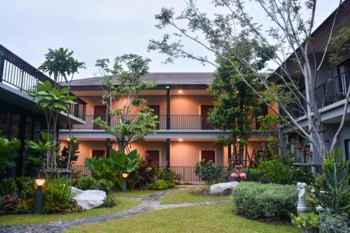 an exterior view of a building with a garden at JINGLE JUNGLE RESORT KHAOYAI in Mu Si