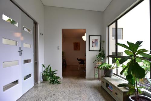 a hallway with potted plants in a house at Arthouse Six in Margaret River Town