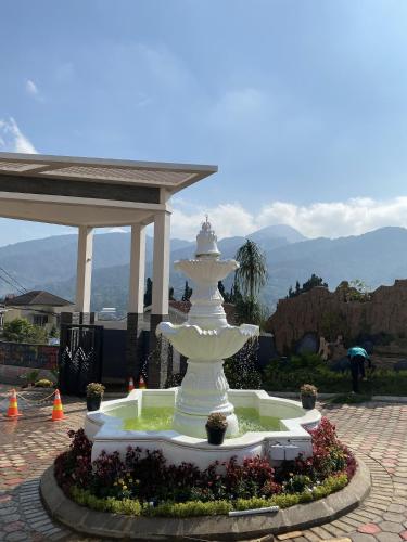 a white fountain in the middle of a courtyard at Marseillia Hills in Puncak