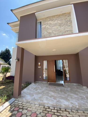 a houserendering of a home with a front door at Marseillia Hills in Puncak