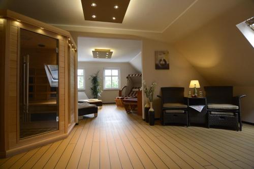 a living room with a couch and chairs and a mirror at Apartment Hotel Rüther in Papenburg