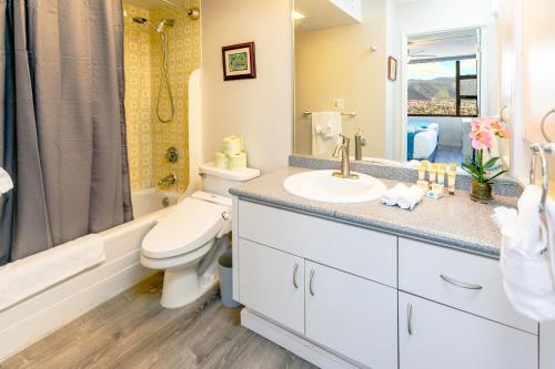 a bathroom with a toilet and a sink and a shower at Warm Aloha Vibes, Mountain Views, Short Walk to Beach, and Free Parking in Honolulu