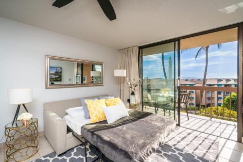 a living room with a couch and a balcony at 1BD Condo with Ocean Views: 40% OFF, Self Check-In in Kihei