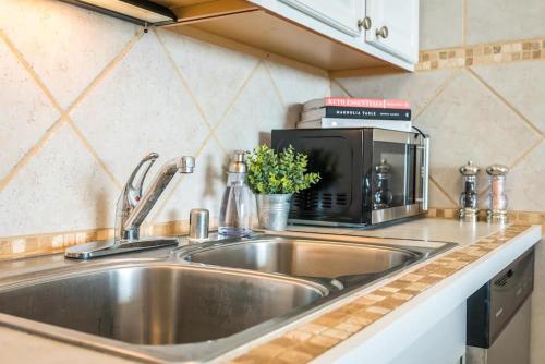 a kitchen counter with a sink and a microwave at 1BD Condo with Ocean Views: 40% OFF, Self Check-In in Kihei