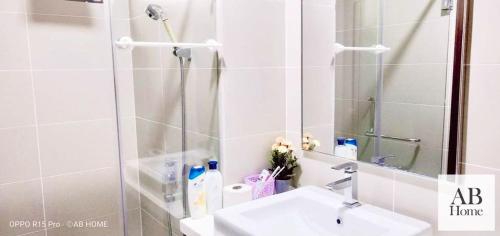 a bathroom with a sink and a shower with a mirror at ABHOME "JAPAN SUITE" #GreenHaven #Olympic Pool #360"SeaView #JB in Johor Bahru
