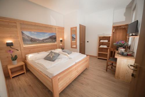 Postel nebo postele na pokoji v ubytování Garni Le Prealpi