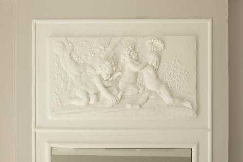 a white painting of two people on a wall at Le Rempart du Midi in Angoulême