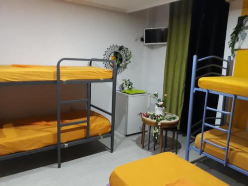 a room with two bunk beds and a table at Hostal Mayor in Alicante