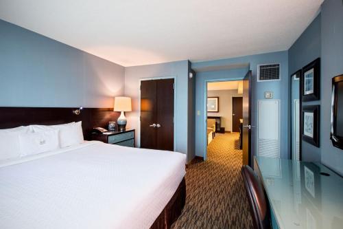 a hotel room with a large white bed and a desk at Crowne Plaza Hotel Glen Ellyn/Lombard by IHG in Glen Ellyn