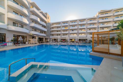 a large swimming pool in front of a hotel at Bio Suites Hotel & Spa in Rethymno