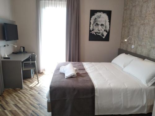 a bedroom with a bed with a picture of a man at L'aja della Mirusina - Piedmont Resort Monferrato Langhe in Canelli