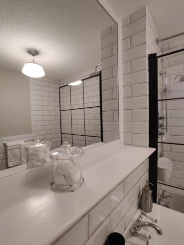 a white bathroom with a sink and a mirror at Anchors Away in Ayr