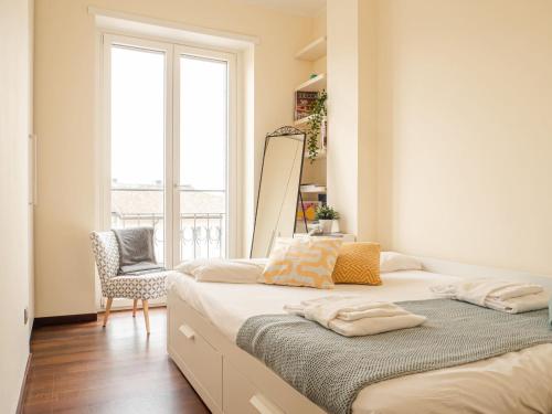 A bed or beds in a room at The Best Rent - Bright two rooms apartment near Cattolica University