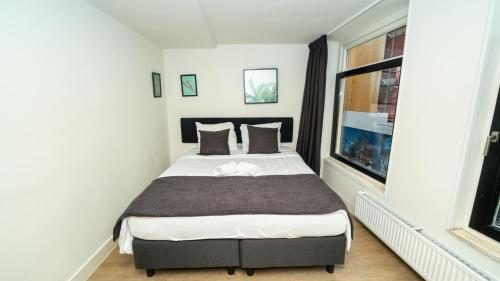 a bedroom with a bed and a window at Leidse Square City Centre Private Apartments in Amsterdam