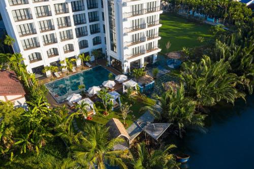 an aerial view of a building and a swimming pool at Shining Riverside Hoi An Boutique & Spa in Hoi An