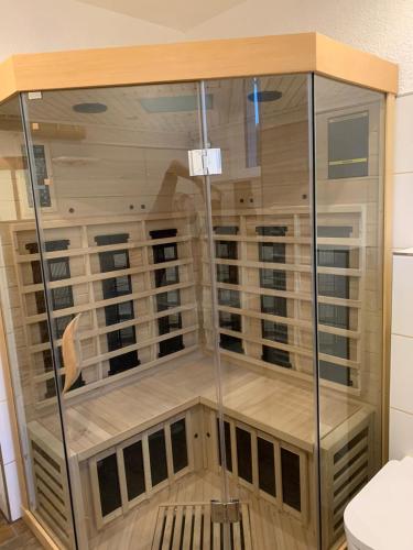 a large glass shower in a bathroom with a toilet at Ferienhaus Kaufmanns Cafe in Kurort Oberwiesenthal