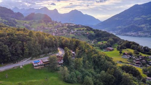 an aerial view of a town on a hill next to a lake at Hotel Cafe Seeblick in Filzbach
