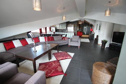 a living room with a couch and a table at Hotel Hullu Poro in Levi