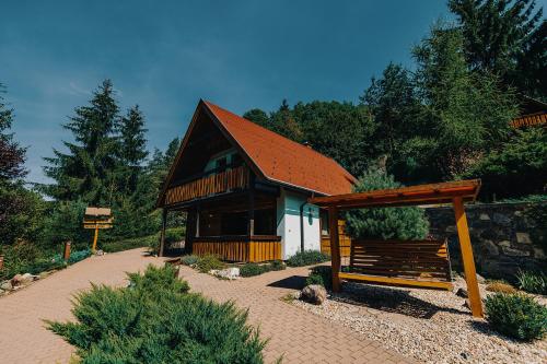 a small house with a red roof and a pavilion at Ekoma rezort in Zvolen