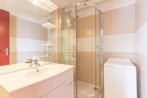 a bathroom with a sink and a shower at travelski home classic - Résidence Phénix in Le Corbier