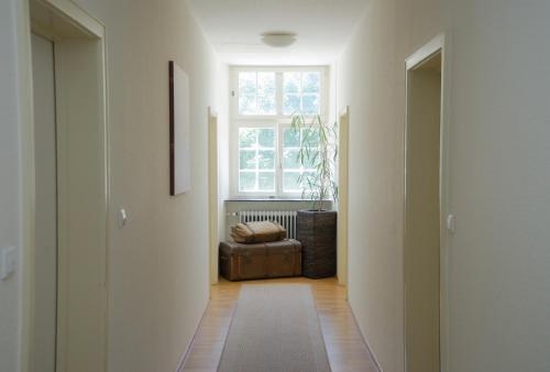 a hallway with a couch and a window in a room at Hotel Gasthaus Schützen in Freiburg im Breisgau