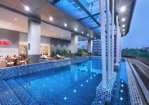a large swimming pool in a building at ASTON Kartika Grogol Hotel & Conference Center in Jakarta