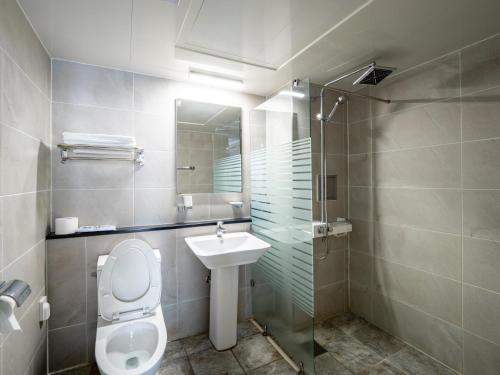 a bathroom with a toilet and a sink and a shower at Jeju Moseulpo Hotel in Seogwipo