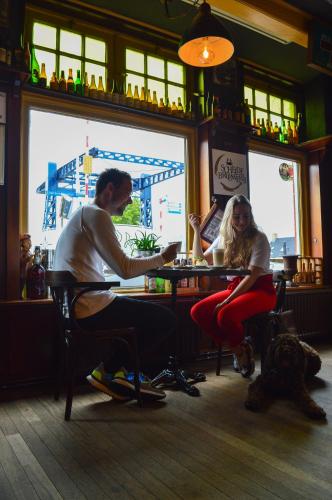 a man and a woman sitting at a table in a restaurant at HCR Teernstra in Balk