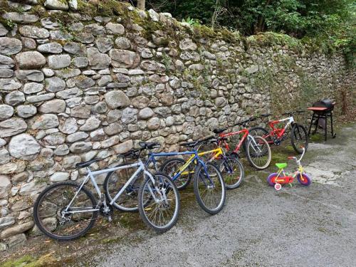 a group of bikes parked next to a stone wall at Casa El Campano in Ontaneda