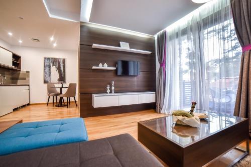 a living room with a couch and a table at Apartmani Buket Zlatibor in Zlatibor