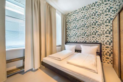 Кровать или кровати в номере Design Apartments -Innenstadt, Bäckerstr 8