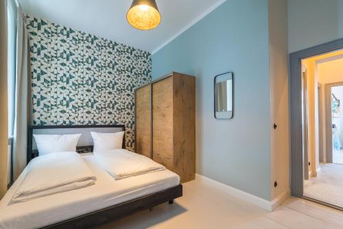 Кровать или кровати в номере Design Apartments -Innenstadt, Bäckerstr 8