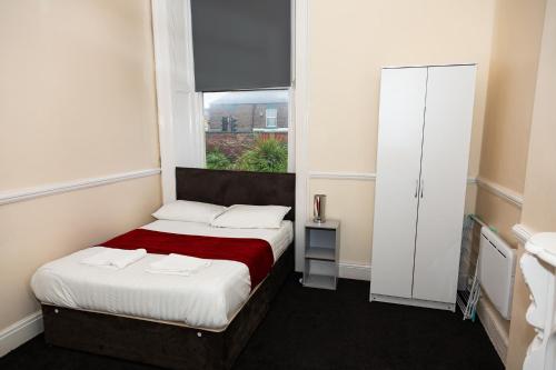 a small bedroom with a bed and a window at AA Sunderland City South in Sunderland