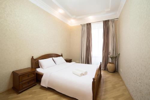 a bedroom with a large white bed and a window at Lux Apartment on Virmenska 3- with 2 separate bedrooms in Lviv