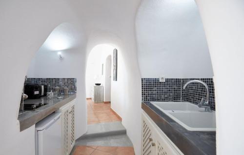 a white bathroom with a sink and a tub at Elegant Santorini House Villa Horizon Caldera View-Outdoor Hot Tub Oia in Thólos