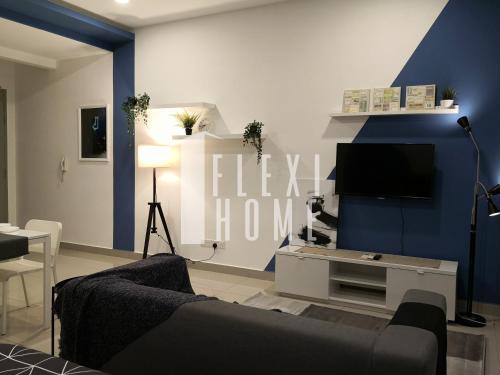 a living room with a couch and a flat screen tv at 1-2 Guests, Cybersquare Private Studio - Cyberjaya, Flexihome-MY in Cyberjaya