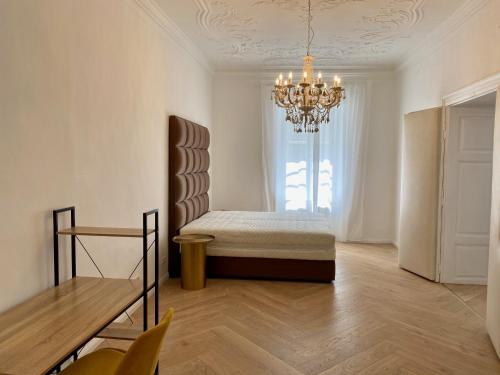 a bedroom with a bed and a chandelier at Die Burg 23 in Klagenfurt