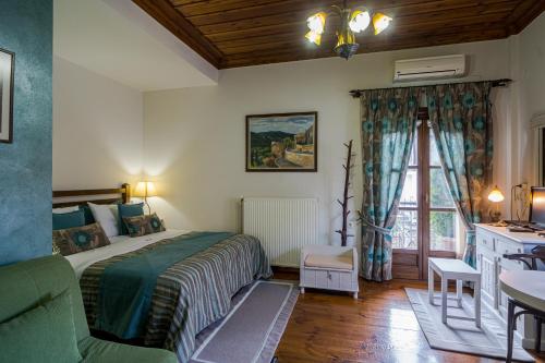 a bedroom with a bed and a desk and a window at Studio Iviscos in Mikrón Khoríon
