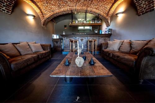 a living room with two couches and a table at La Belle Étable in Dinant