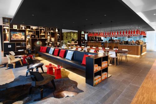 a room filled with lots of different types of furniture at citizenM Rotterdam in Rotterdam