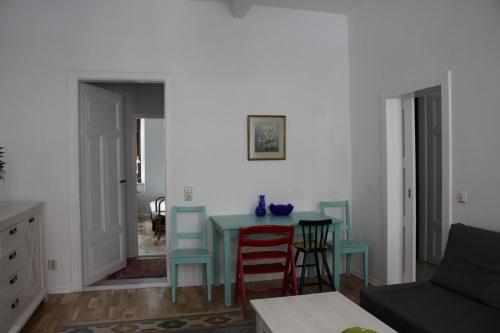 ein Wohnzimmer mit einem Tisch und einigen Stühlen in der Unterkunft Gemütliche Ferienwohnung in Görlitz in Görlitz