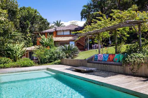 a home with a swimming pool and a house at Casas da Lia in Trancoso